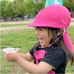 水の入った霧吹きで水遊びをしている園児